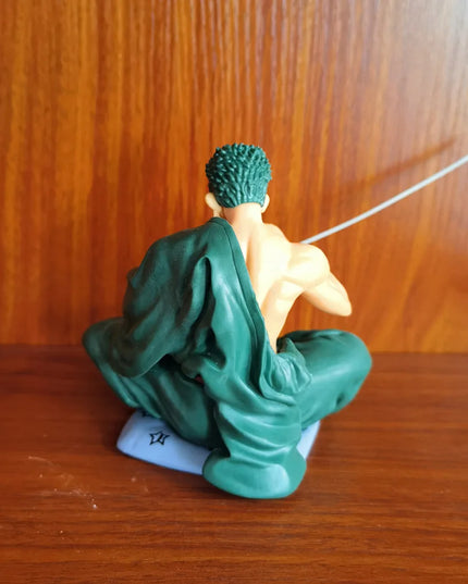 Zoro Sitting with Sword Figurine: Detailed Anime Collectible for Fans, Perfect Gift for Sword Enthusiasts & Decor Lovers.