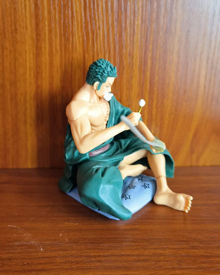Zoro Sitting with Sword Figurine: Detailed Anime Collectible for Fans, Perfect Gift for Sword Enthusiasts & Decor Lovers.